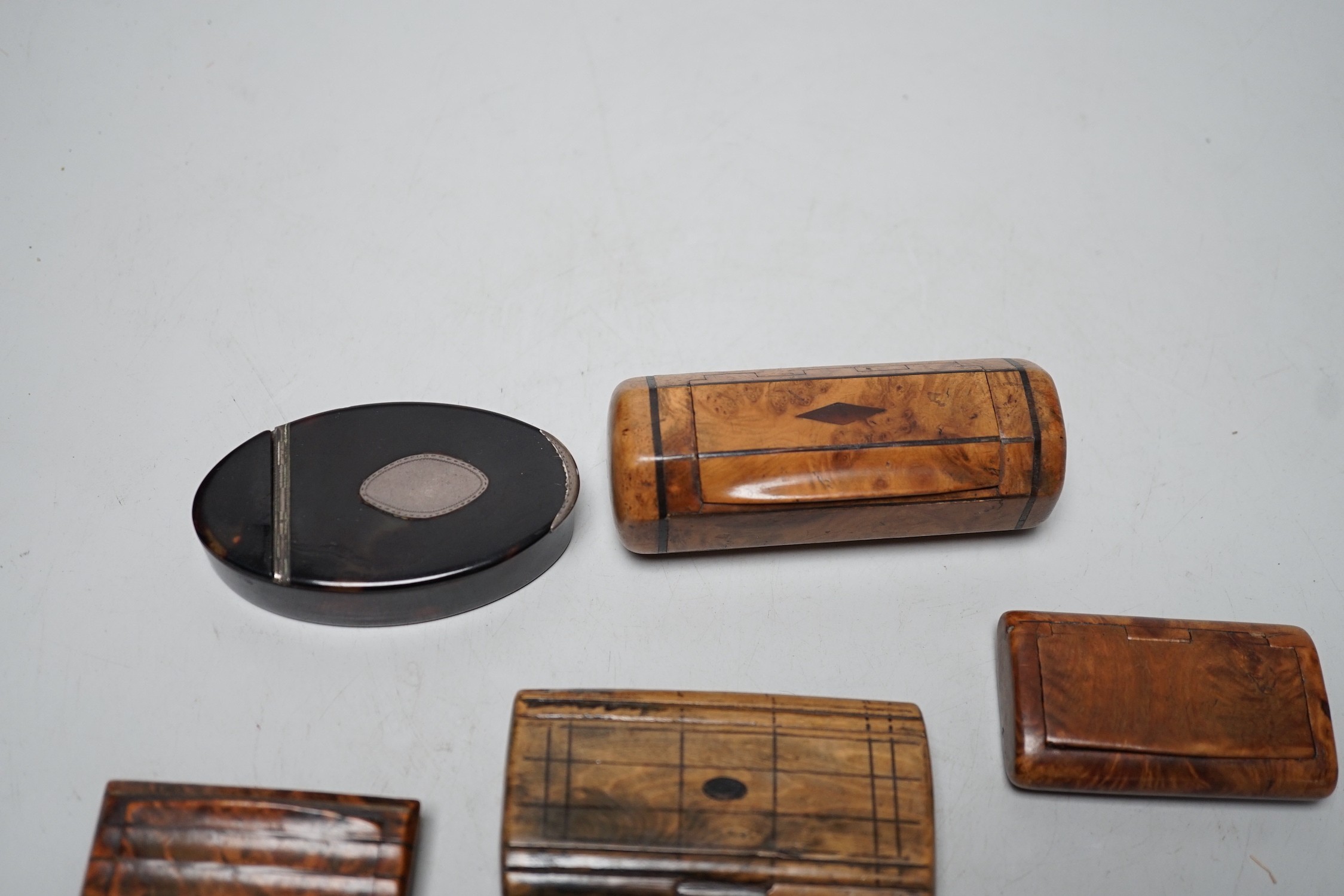 Two 19th century tortoiseshell snuff boxes and four treen snuff boxes.